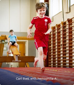 Carl, who lives with hemophilia A, is shown in a gymnasium, running toward the camera on a gymnastic mat and smiling