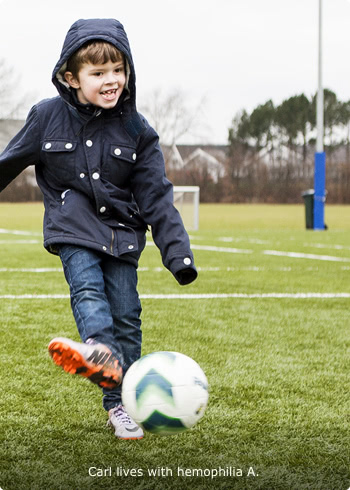 Carl, who lives with hemophilia A Carl, who lives with hemophilia A, outdoors, standing on a soccer field and kicking a soccer ball
