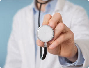 Closeup of a stethoscope held by a healthcare professional 