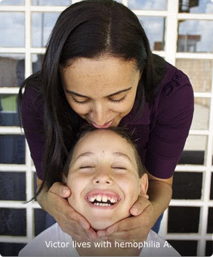 Victor, who lives with hemophilia A Victor, who lives with hemophilia A, is shown seated with his eyes closed and smiling while his mother stands behind him, holding his face with her hands